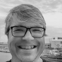 Head-on portrait of Lambert Heller, beaming with a smile.
